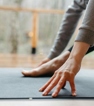 Close-up of a person's feet on an exercise mat, showing focus on grounding.